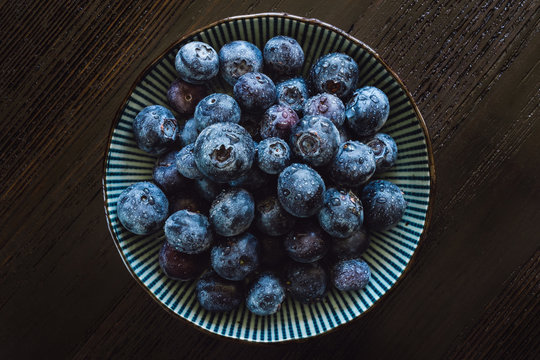 Bowl of Blueberries on Dark Table