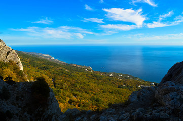 a view of the sea and the spring forest from a high mountain in the Crimea, and over the sea sweep across the clouds