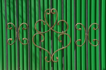 texture of a steel forged pattern on a green iron fence