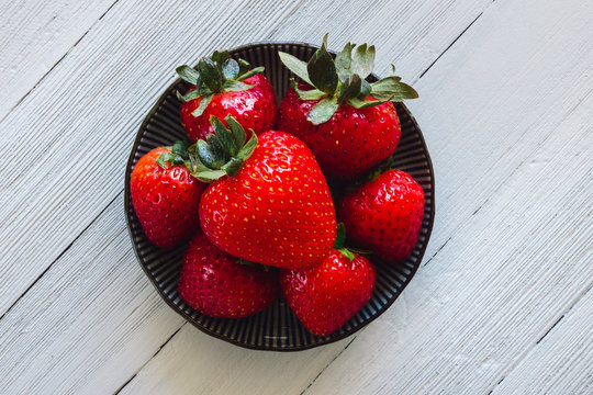 Centered Bowl of Strawberries on White Table