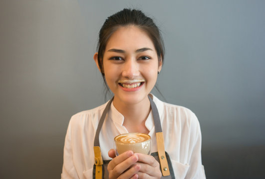 Barista Smiling Young Asian Woman Drink Coffee Making A Mess  Milk Foam On His Mouth