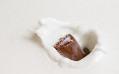 Chocolate falls in milk
