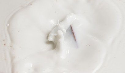 Chocolate falls in milk
