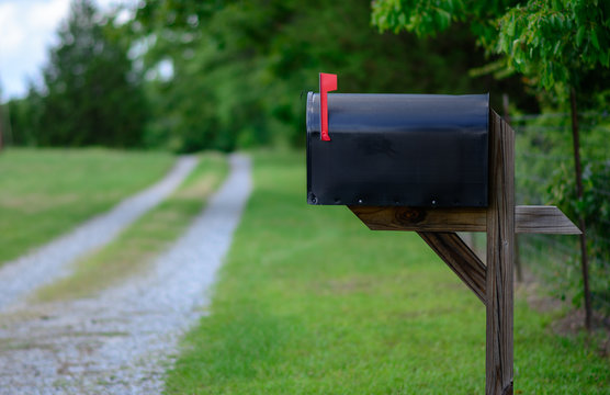 Rural mailbox flag raised country road