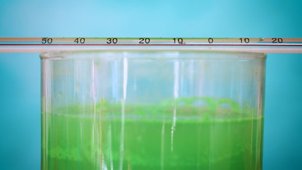 Flasks, test tubes with test different compositions, green background.	