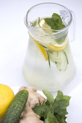 Health care, fitness, healthy nutrition diet concept. Fresh cool lemon cucumber mint infused water, cocktail, detox drink