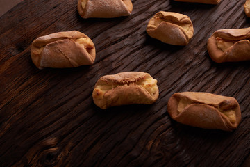 Cookies with Cottage cheese baked in oven, on wooden table and black background. Close up, selective focus. Concept of homemade food