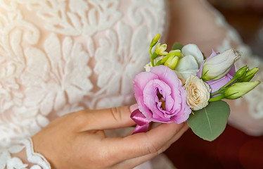 Bride's hands with a bouquet for the groom. place for text