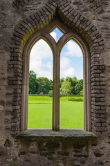 Stone window of a Norman Fort looking out to rural countryside.