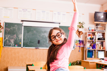 Fototapeta na wymiar Happy smart girl in classroom