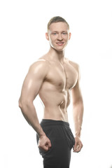Fototapeta premium beautiful bodybuilder shows off tense body on white background