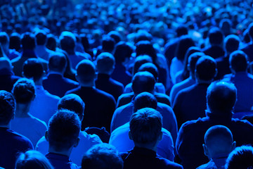 Audience listens to the lecturer at the conference hall