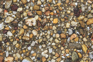 Abstract stones of different shapes background / Top view of pile of pebbles of various colours forming textured background. Texture made with elements of nature.