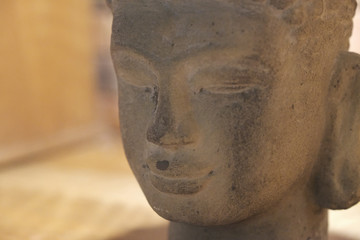 Fototapeta na wymiar Face with eyes closed stone head of a Buddha statue close-up