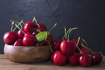 natural cherries piled on rustic wood bottom