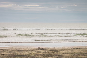 Landscape image of a beautiful soft sand beach on the Kapiti Coast of New Zealand