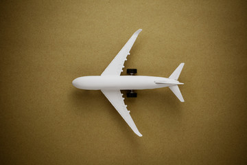 Model airplane on old paper background.