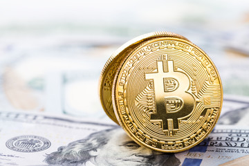 Bitcoins on dollar banknotes background
