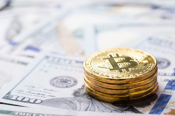 Bitcoins on dollar banknotes background