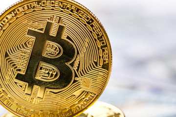 Bitcoins on dollar banknotes background