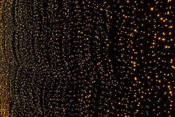 Golden bokeh of small light bulbs