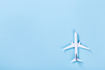 White blank model of passenger airplane on serenity colored paper texture