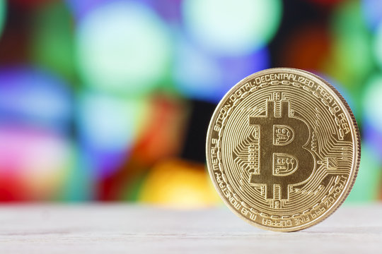 The golden bitcoin on marble table and bokeh background, golden bitcoin symbol of bitcoin crytocurrency from blockchain technology.