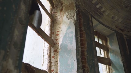 Ruined window shutters. The results of military bombin g. Shards of glass of a broken window. The shutters at the windows fell apart. 