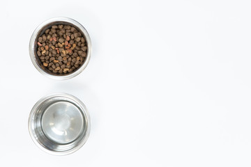 Dry dog food in metal bowl, top view and flat lay