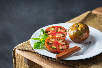 Assortment of red ripe organic farmer tomatoes on a table