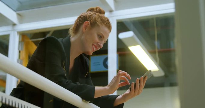 Businesswoman using mobile phone in office 4k