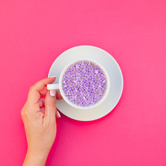 Cup of beautiful lilac flowers infused water