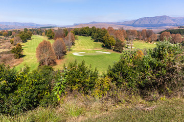 Fototapeta na wymiar Scenic Golf Course In Autumn Fall in Mountains Birds Eye Landscape