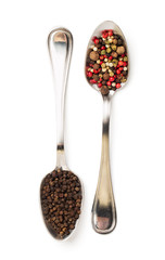 Different spices in iron spoons isolated on white