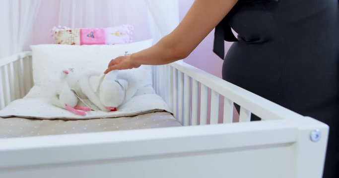 Pregnant woman shopping for the baby cot at shop 4k