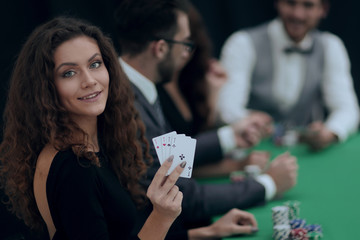 beautiful woman showing a combination of four aces.