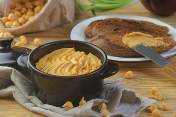 hummus with croutons on a wooden table