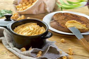 hummus with croutons on a wooden table