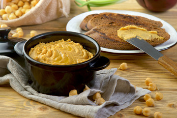 hummus with croutons on a wooden table