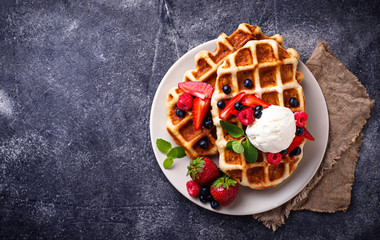 Fototapeta na wymiar Belgium waffles with berries and ice cream