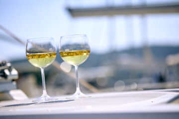 Pair of wineglasses against the yacht