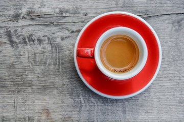 Espresso morning coffee red cup on wooden rusty table