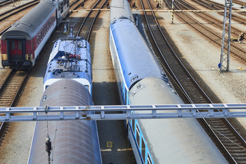 Electric locomotive and a train standing on the railroad tracks