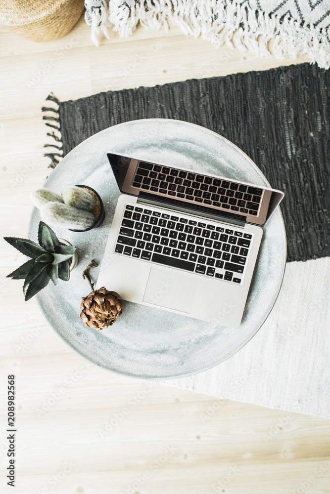 Wall mural laptop, protea flower and succulent on tray. flat lay, top view still life hero header concept.
