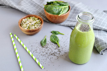 Green spinach smoothies in jar with seeds and nuts, healthy food concept