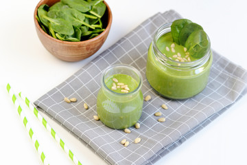 Green spinach smoothies in jar with seeds and nuts, healthy food concept