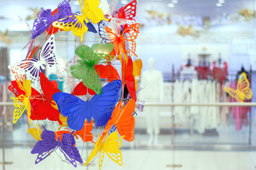 Interior decor of plastic multi-colored butterflies. Close-up.