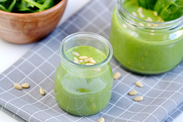 Green spinach smoothies in jar with seeds and nuts, healthy food concept