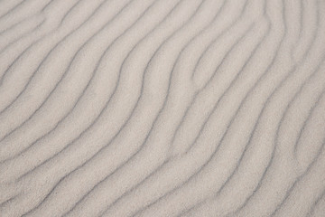 Fototapeta na wymiar Interesting sand texture background, dunes, shadow play.