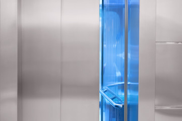 A slightly open elevator door in the mall.